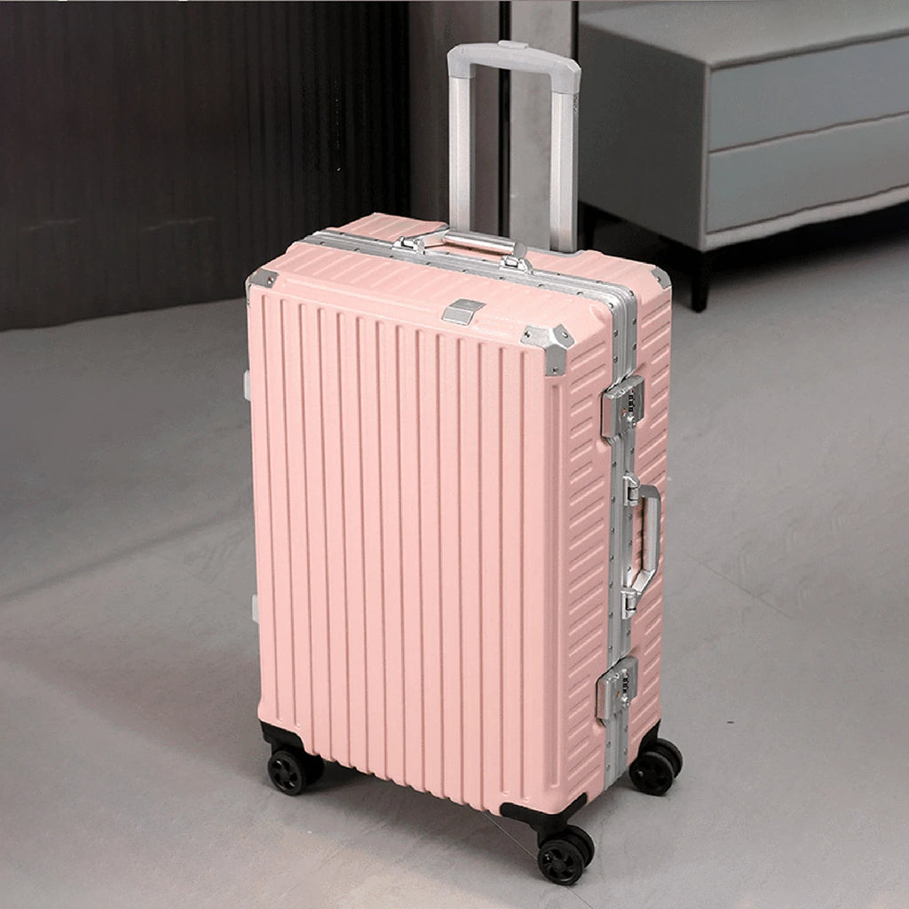 Pink suitcase with silver accents on a neutral background