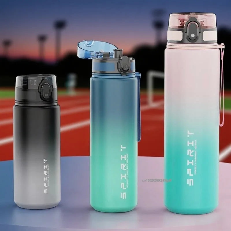 Three Spirit brand water bottles on a sports field background