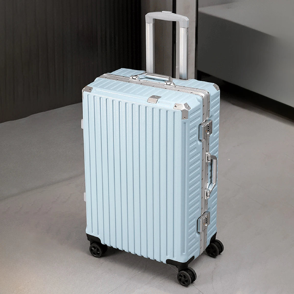 Light blue suitcase with silver accents on a neutral floor