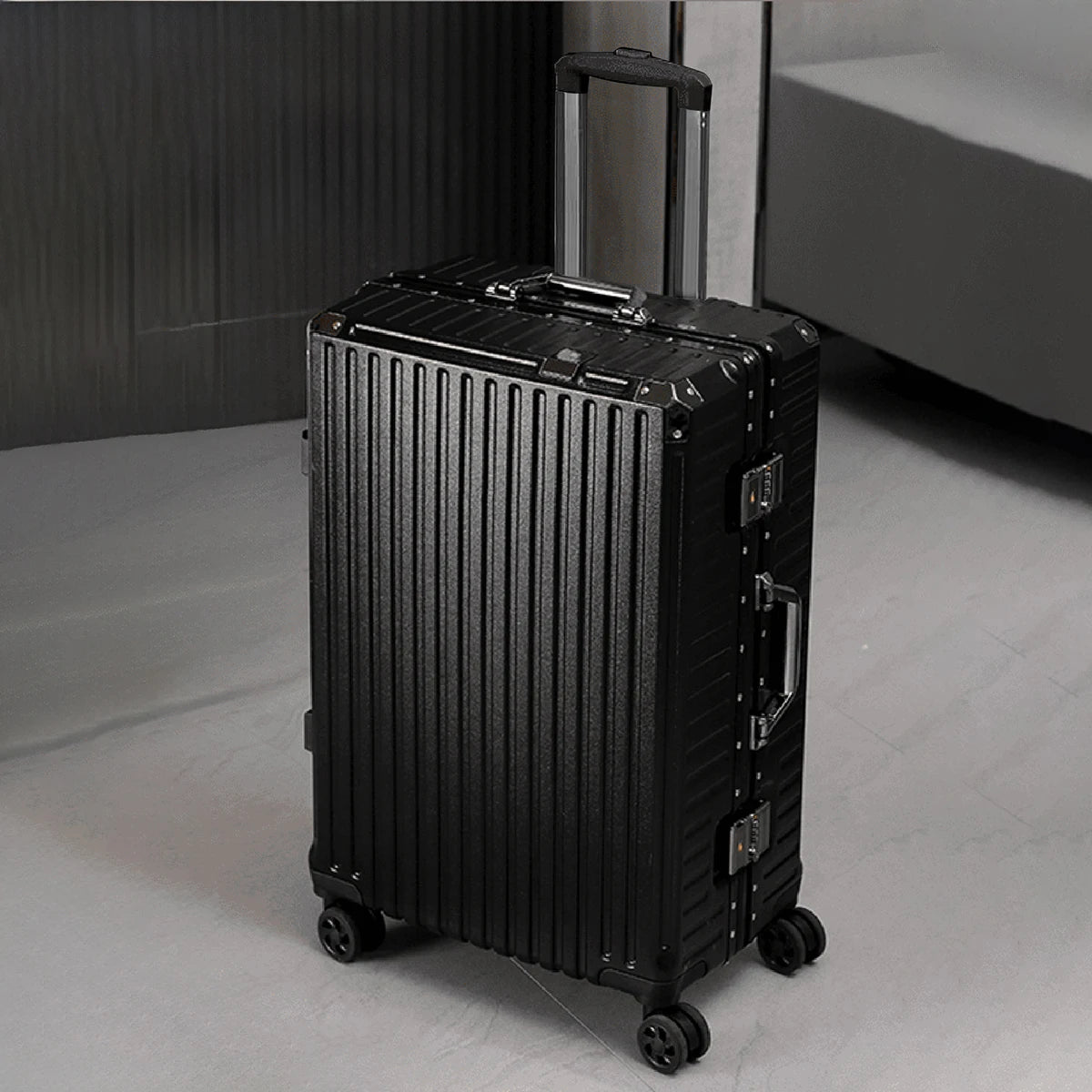 Black suitcase with a ribbed texture on a light gray floor.